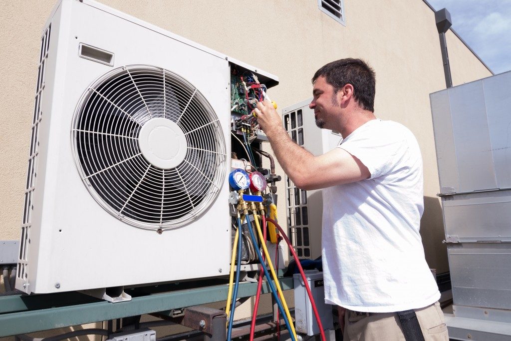 HVAC technician working on a condensing unit