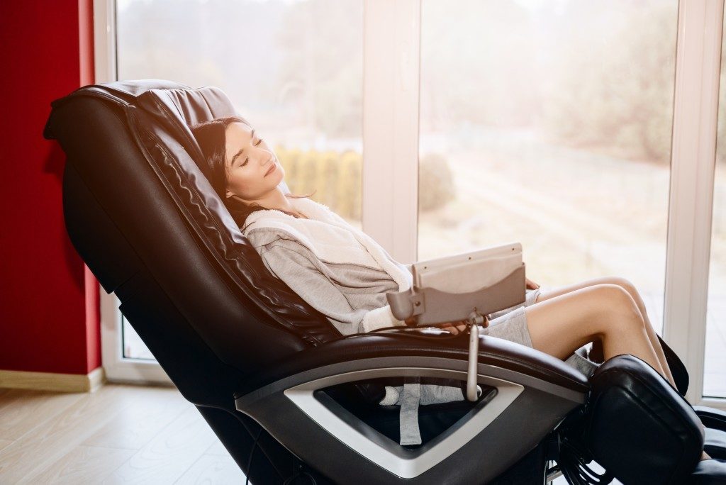 Woman relaxing on massage chair