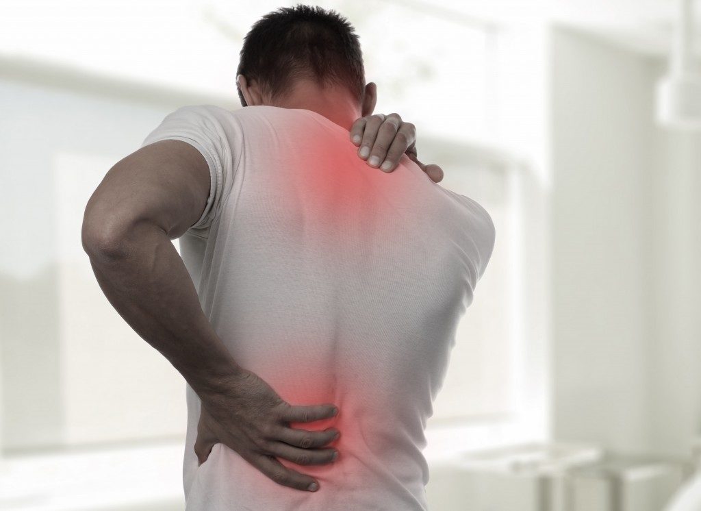 Man suffering upper and lower back pain
