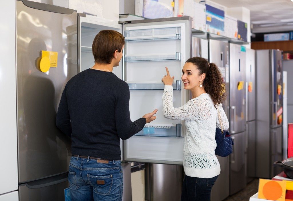 couple buying a refrigerator for their home