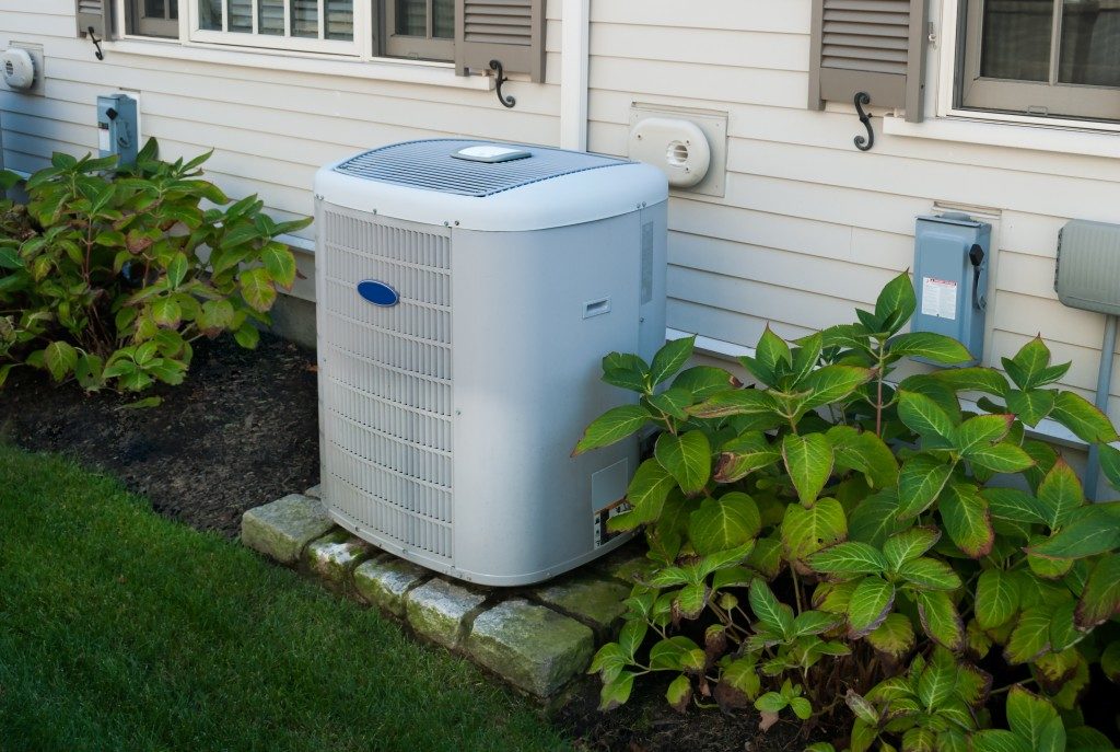 white heat pump at the back of a home