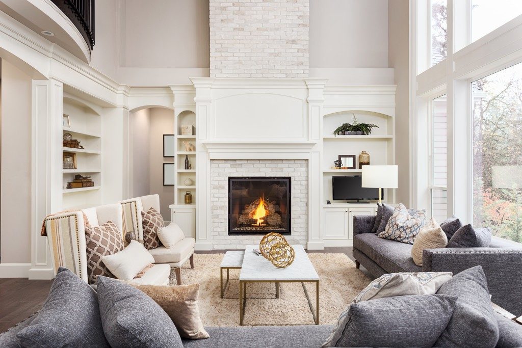 luxurious living room with comfortable seats by the fireplace