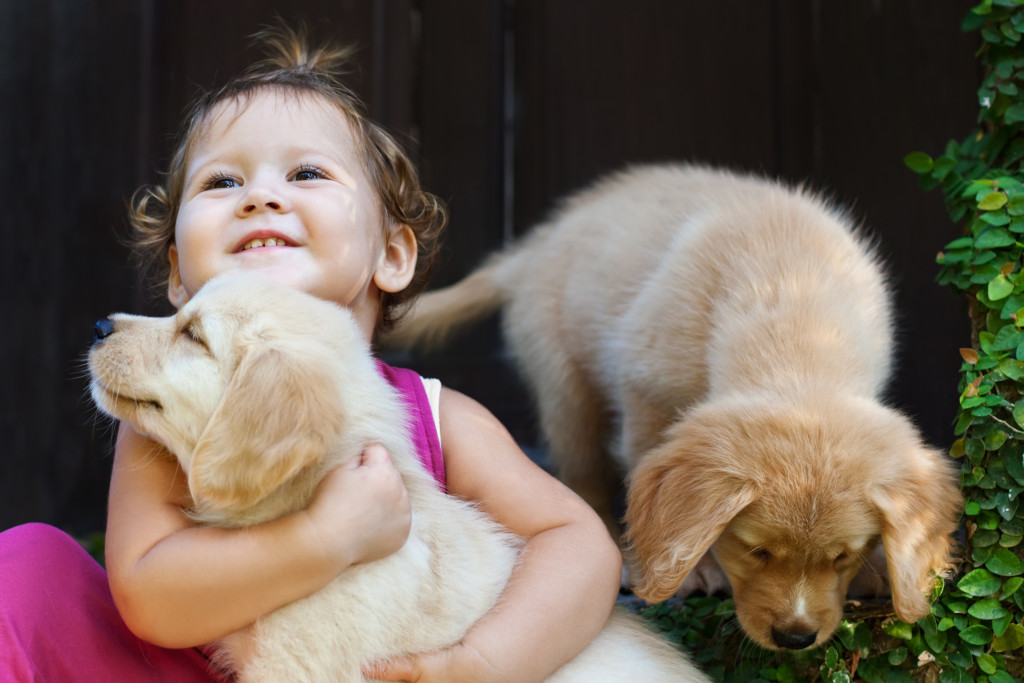 child holding a dog