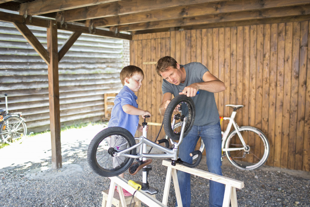 father and son fixing a bike
