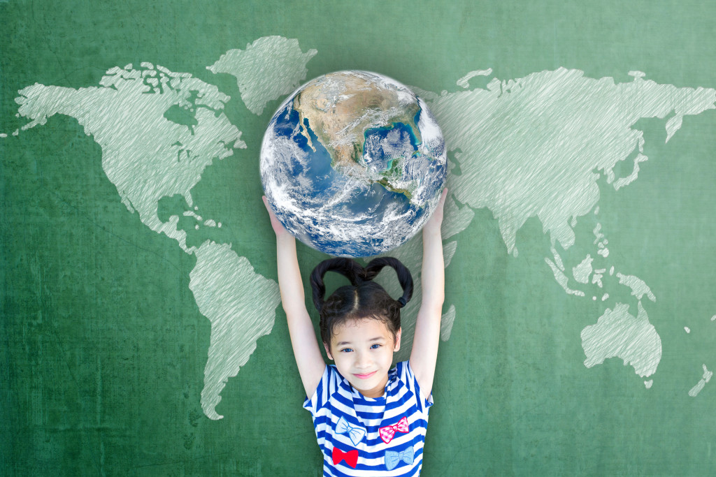 a kid holding a globe