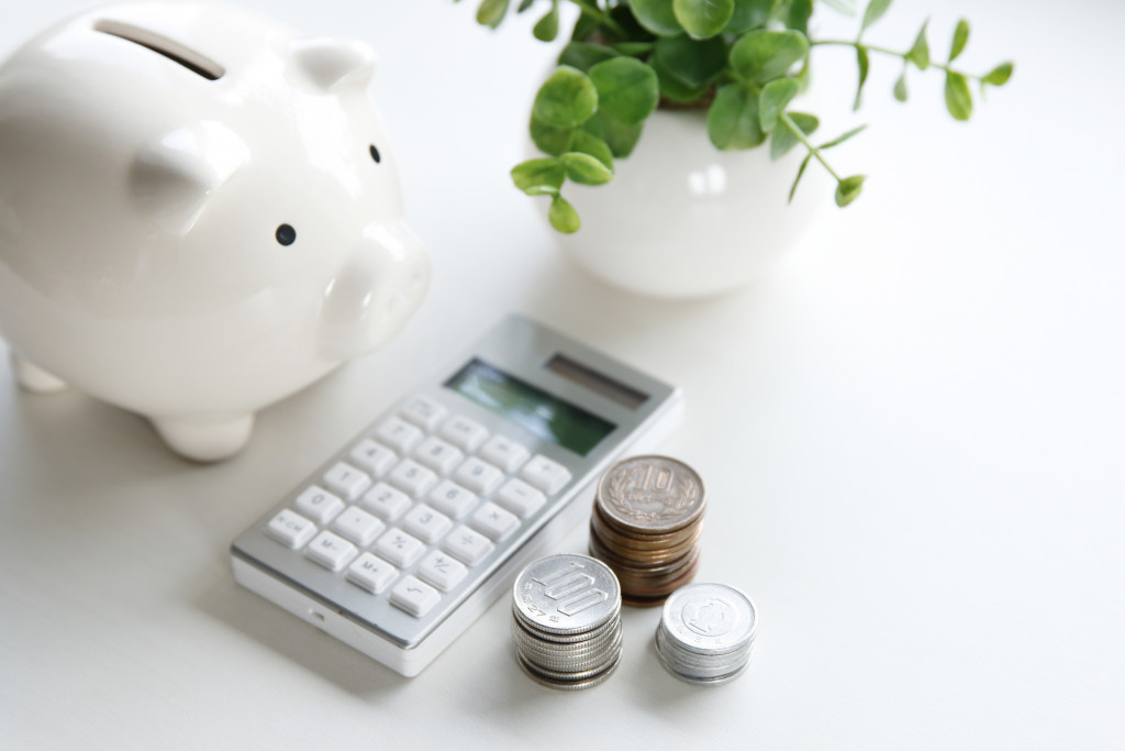 piggybank, calculator, and coins
