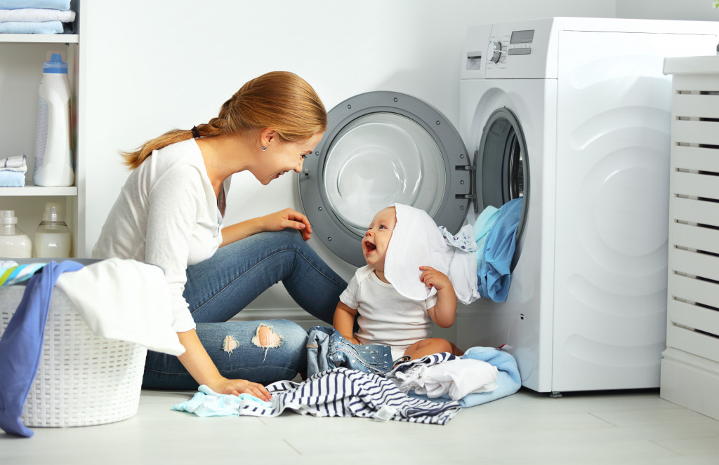 mother and baby doing laundry