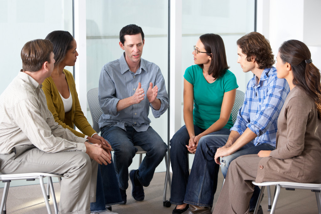 People listening to a man story in support group