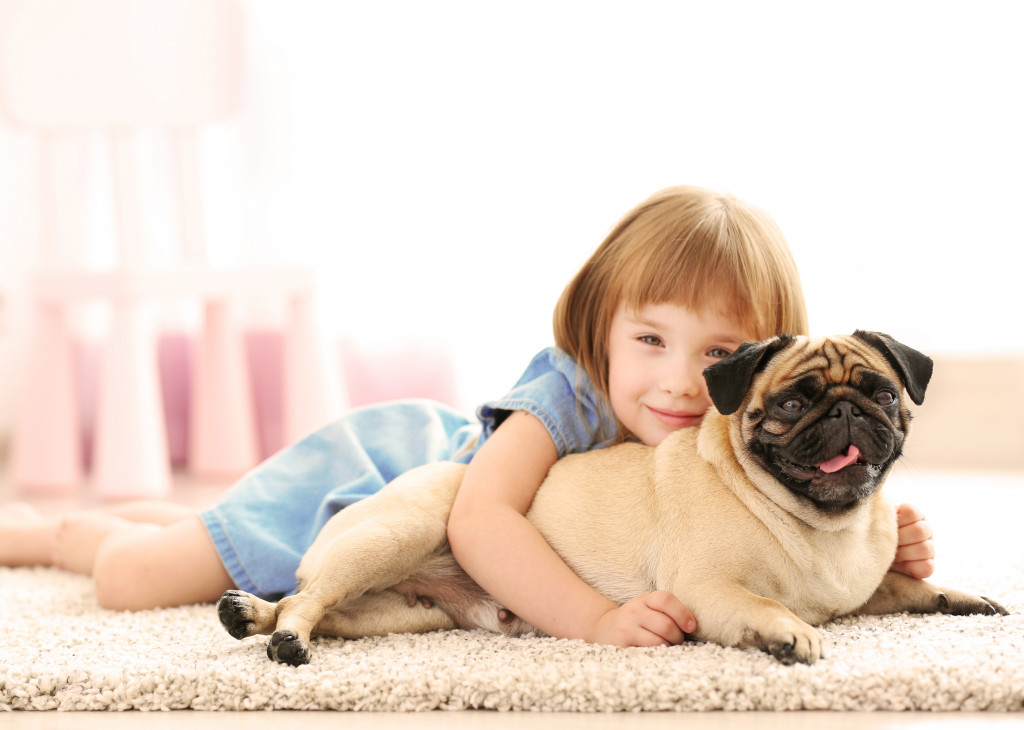 child hugging her pet dog