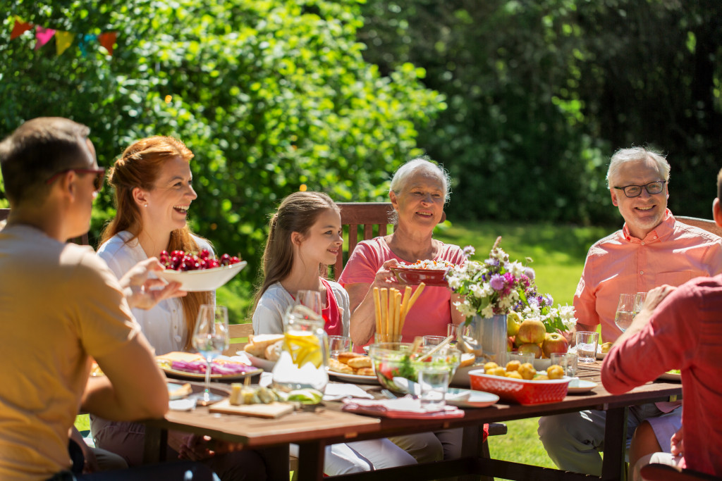 simple family gathering outdoors with food in the table