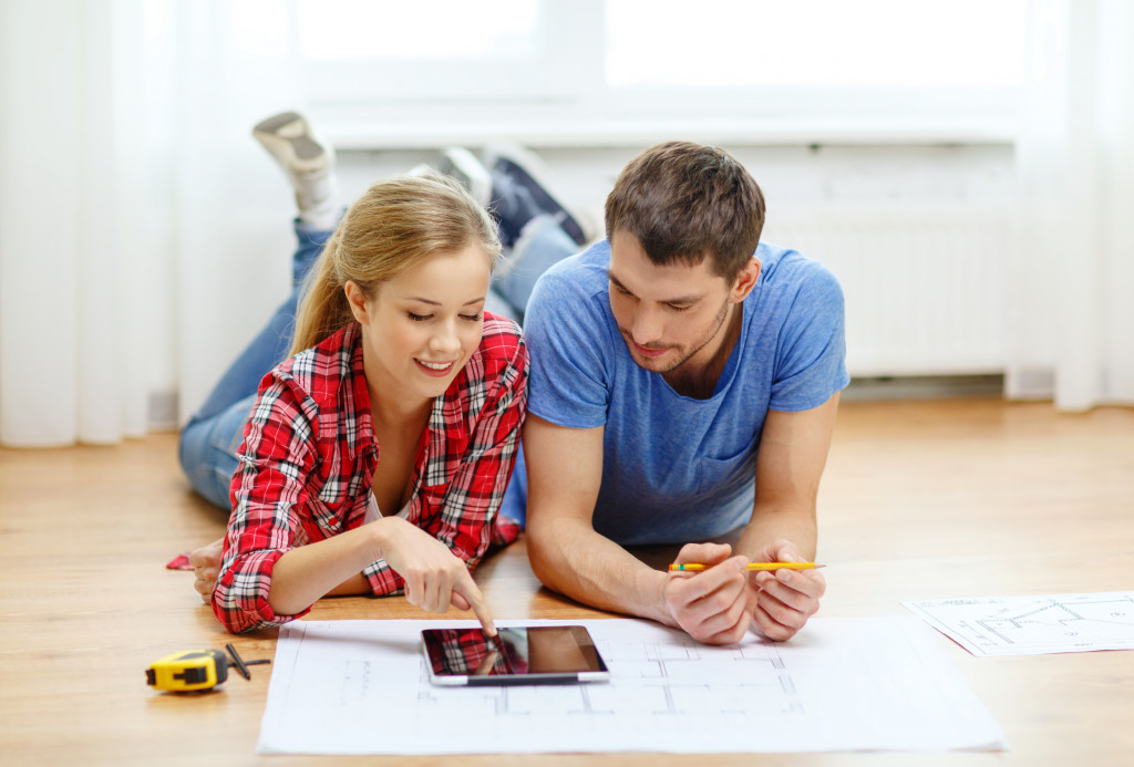 Young couple checking for remodeling ideas using a tablet.