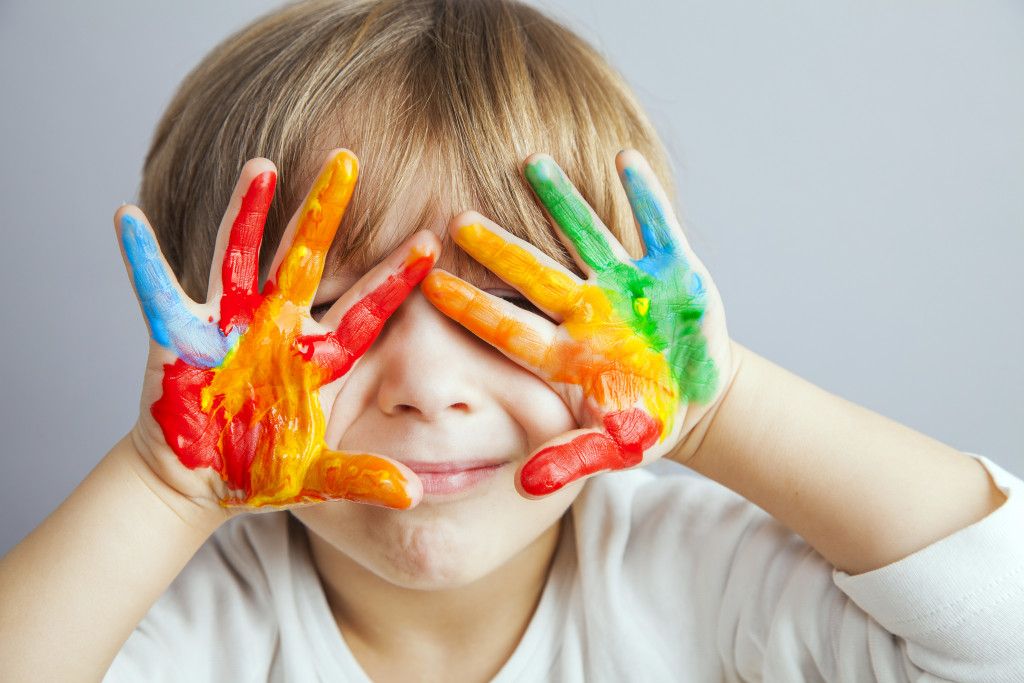 Paint in child's hands and covering eyes