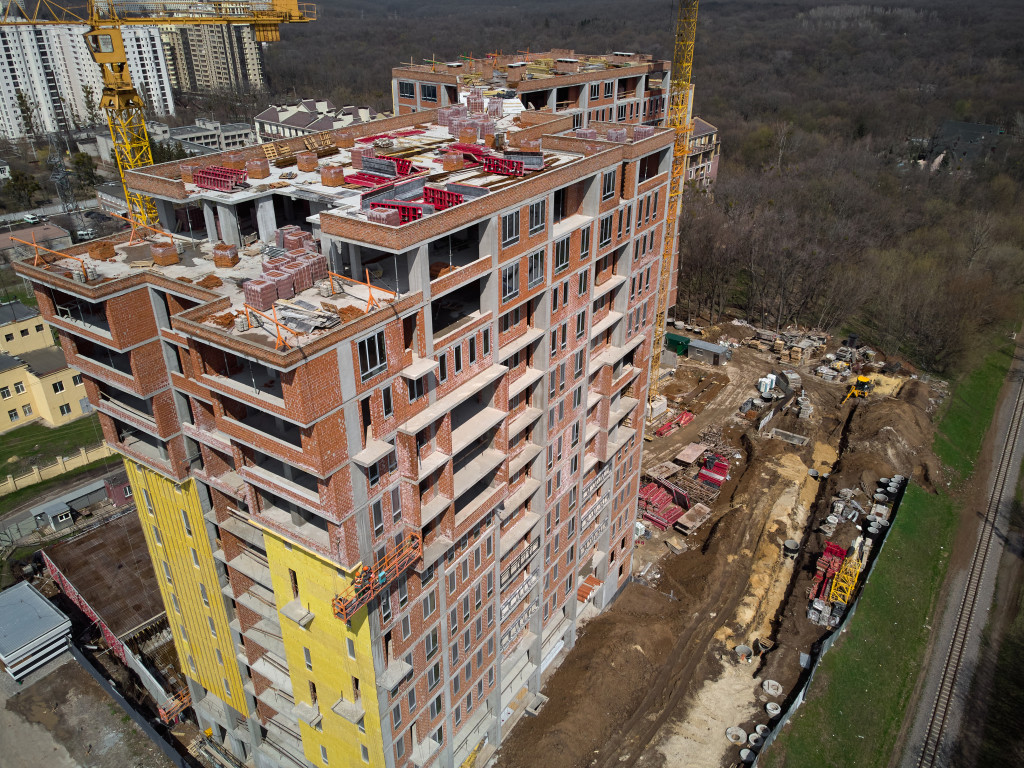 Aerial view of a building under construction with equipment on the ground.