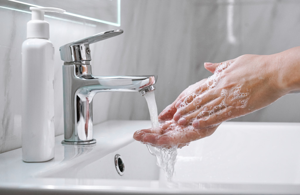 rubbing hands rinsing with running water