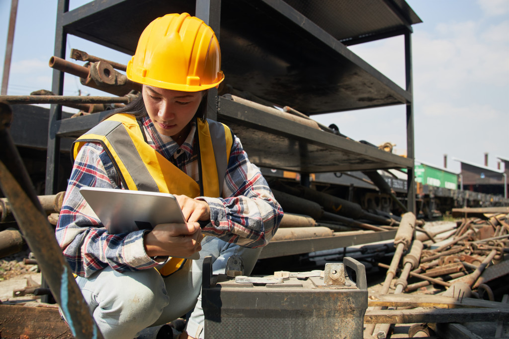 Female construction worker using a tablet to check supplies.