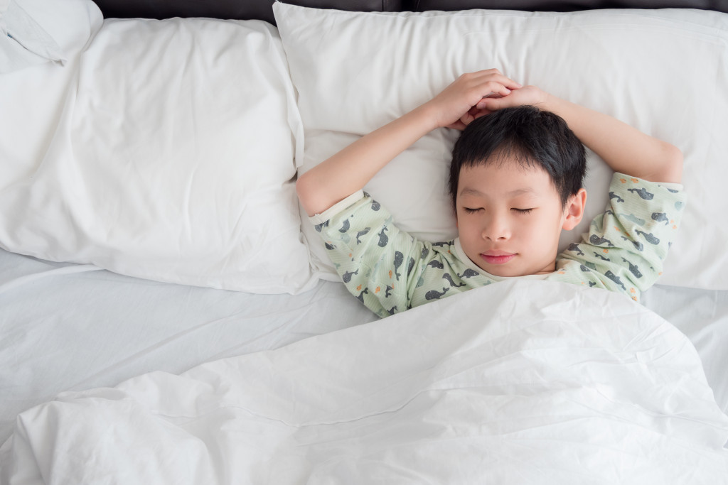 a young boy in bed sleeping