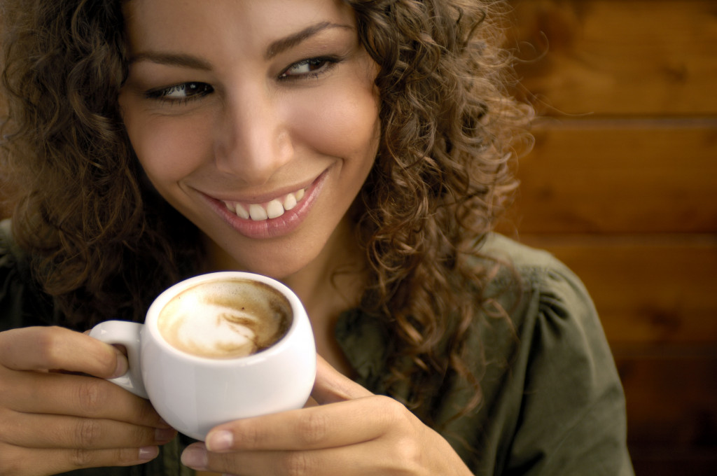 a beautiful woman smiling with coffee